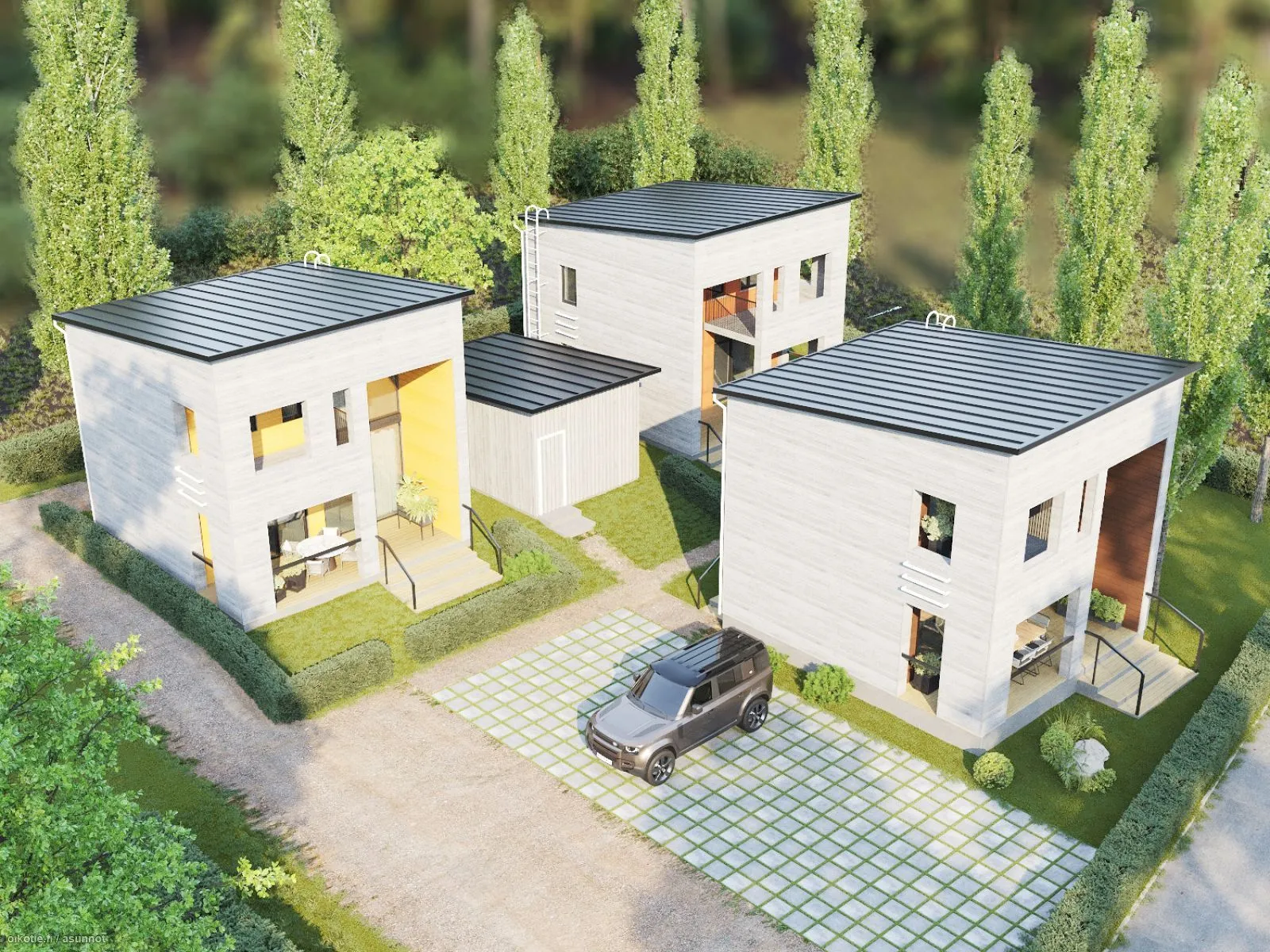 Ilmakuva kolmesta modernista, valkoisesta talosta, joissa on tummat katot, harmaa auto pysäköitynä kivettyyn ajotielle, ja vehreä maisema ympärillä.